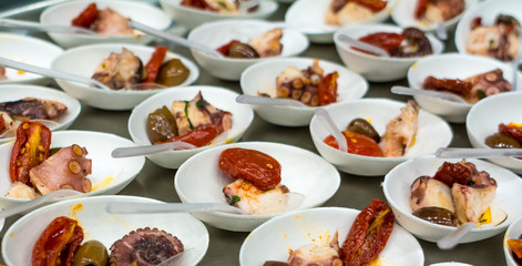 fish appetizer with vegetables in small porcelain bowls