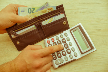 Man using calculator and calculate money in home office