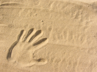 playing with sand on the beach ( single hand shape )