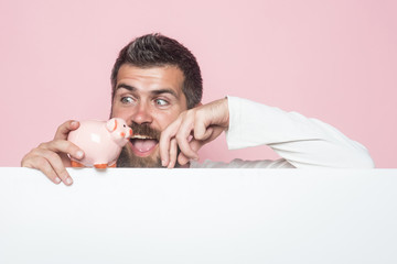 Guy hold moneybox or piggy bank for savings.