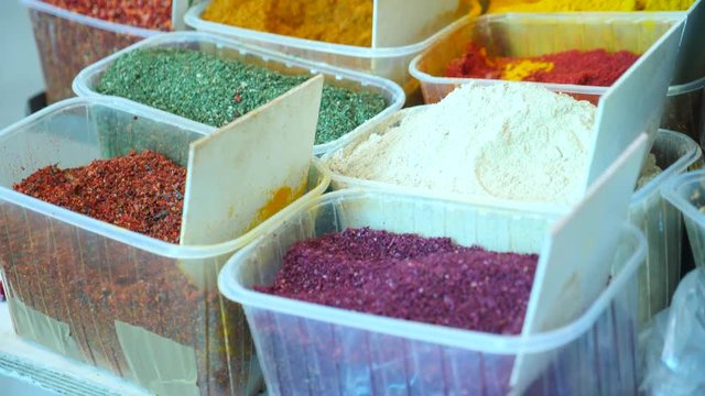 Spices, nuts, dried fruits on display at market on the counter, 4k, slow-motion