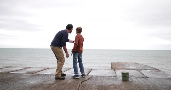 Father helping Son fish