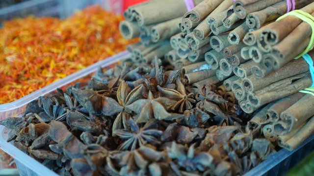 Spices, nuts, dried fruits on display at market on the counter, 4k, slow-motion