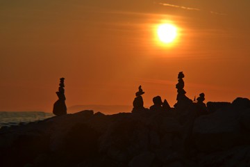 Silhouette of a stones on the beach in the evening at sunset