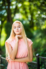 Attractive young woman enjoying her time outside in park with sunset in background.