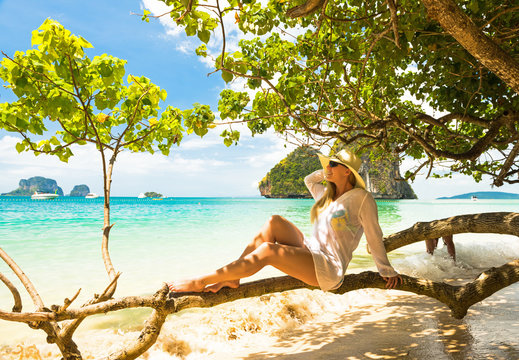 woman in straw hat resting tropical Thailand beach