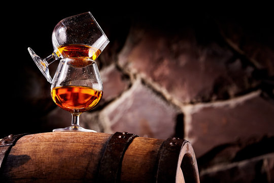 Glass Of Cognac On The Old Wooden Barrel