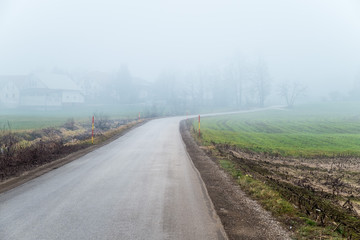 Fototapeta na wymiar Foggy morning on rural road.