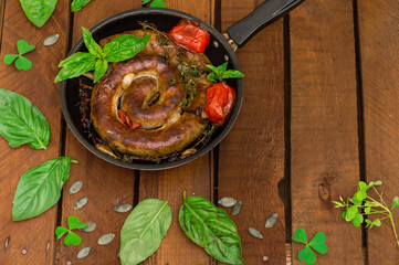 Homemade Pork Sausages in pan with thyme. Rustic wooden background. Close-up. Top view