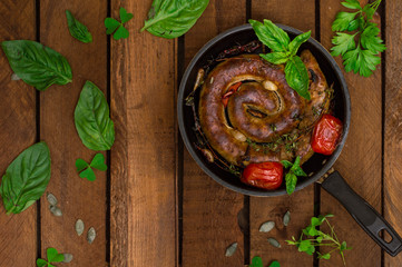 Homemade Pork Sausages in pan with thyme. Rustic wooden background. Close-up. Top view