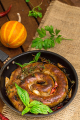 Homemade Pork Sausages in pan with thyme. Rustic wooden background. Close-up. Top view