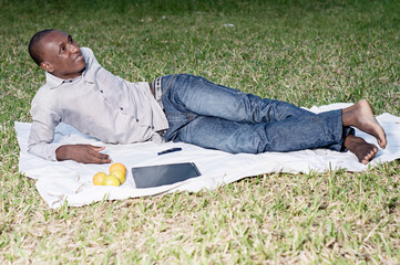 young man lying alone in the park