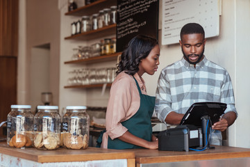 Two African entrepreneurs working behind their cafe counter