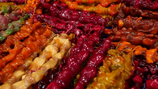 Spices, nuts, dried fruits on display at market on the counter, 4k, slow-motion