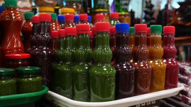 Spices, nuts, dried fruits on display at market on the counter, 4k, slow-motion