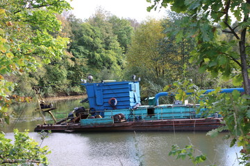 the dredger deepens the river bed in the mainstream