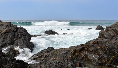 Wave incoming towards rocks