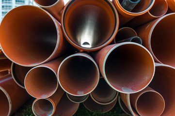 Stack of pvc pipes on a construction site.