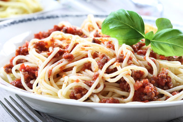 Spaghetti Bolognese with a basil leaf as decoration