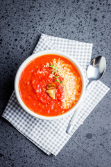   Roasted red pepper and tomato soup with parmesan. Top view, copy space. 