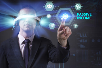 Business, Technology, Internet and network concept. Young businessman working in virtual reality glasses sees the inscription: Passive income