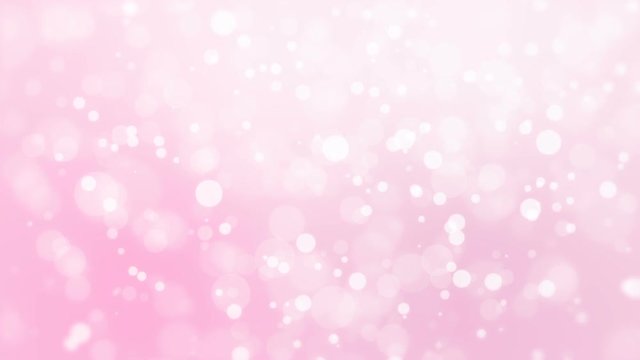 Beautiful romantic pink glowing bokeh background with floating light particles.
