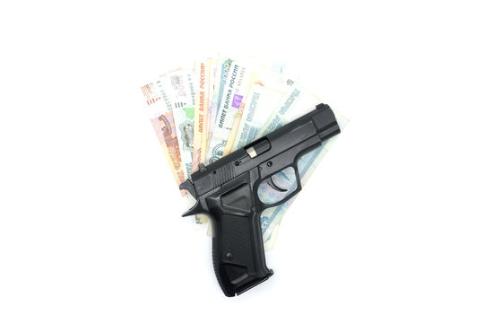 The black gun lies on the money