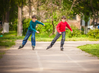 Three children on inline skates in park