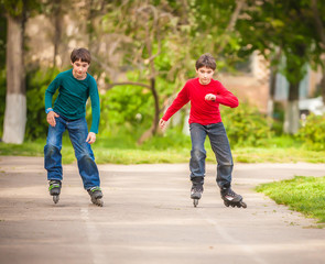 Three children on inline skates in park