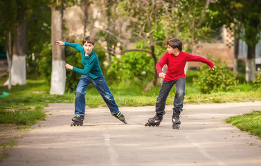 Three children on inline skates in park