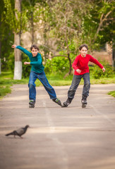 Three children on inline skates in park