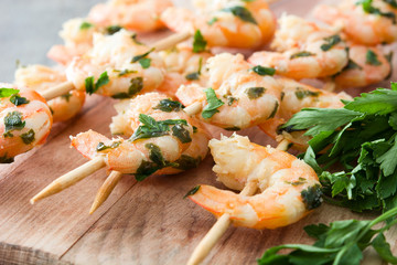 Shrimp skewers on wooden table