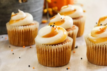 Mini Pumpkin spice cupcakes on autumn background, selective focus