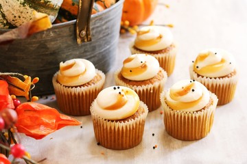 Mini Pumpkin spice cupcakes on autumn background, selective focus