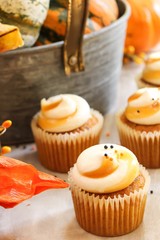 Mini Pumpkin spice cupcakes on autumn background, selective focus