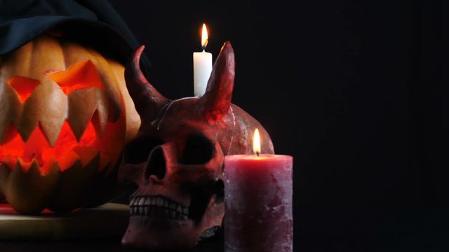 Halloween. Pumpkin, skull, candle, witch. Camera dolly.