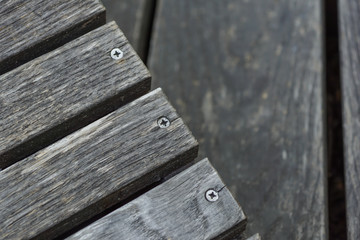 A row of stylish deck chairs . wooden board