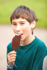 Portrait a young boy eating a tasty ice cream