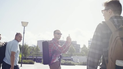 Friendship and holidays concept. Group of friends having good fun on the city streets.