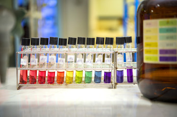 Preparation of standard pH solution, Matching the color of the bottle with the Universal Chemical Indicator in chemistry laboratory. Close up image.