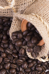 Closeup roasted coffee beans in hemp sack.