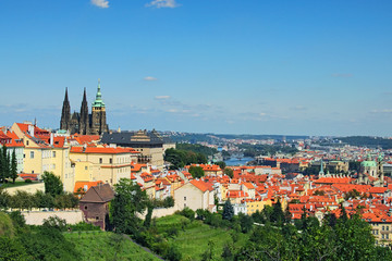 Fototapeta na wymiar A picturesque view to the St. Vitus Cathedral, Hradcany and the Vltava River. Summer sunny day. Prague, The Czech Republic