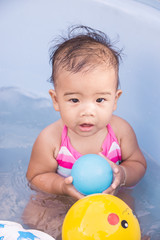 Fototapeta na wymiar Portrait of happy baby girl taking a bath.
