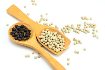 Peppercorn with wooden spoon on white background. Composition isolated over the white background.