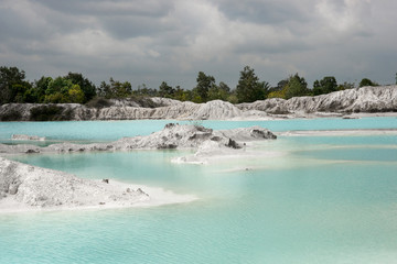 Man-made artificial lake Kaolin and white land containing kaolinite covered with rain water, forming clear blue lake, Air Raya Village, Tanjung Pandan, Belitung Island.
