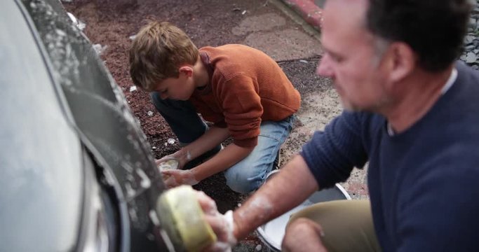 Father and Son washing a car together