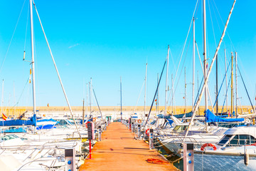 Beautiful luxury yachts and motor boats anchored in the harbor, hot summer day and blue water in...