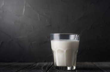 Glass of milk on a dark background