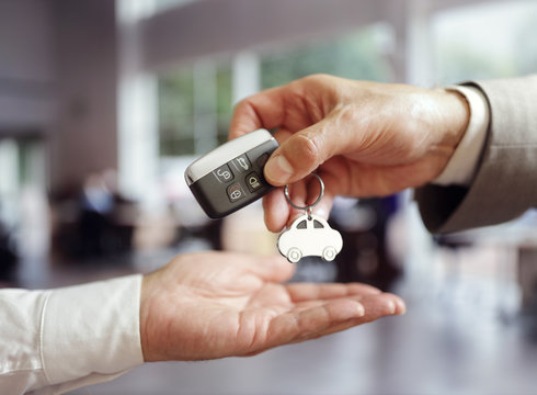 Fototapeta Car sales buying a new car handing over the key