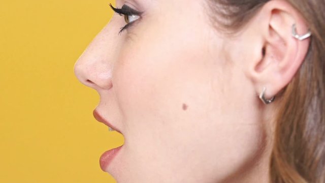Close up side view of pleased woman posing in profile and saying i love you